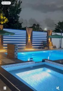 a swimming pool at night with lights on at JC caribe Aparta Hotel #7 in Boca Chica