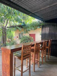 a wooden table and chairs sitting under a patio at VitaHostal in León +36 photos