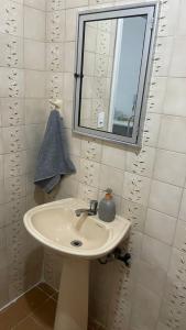 a bathroom with a white sink and a window at Ap Aconchego in Campinas +13 photos