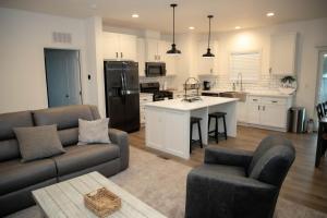 a living room with a couch and a kitchen at Rural Farmhouse in Taylor