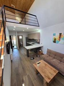 a living room with a couch and a table at Palguin pad loft # 1 in Pucón