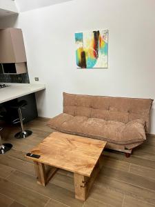 a living room with a couch and a wooden coffee table at Palguin pad loft # 1 in Pucón