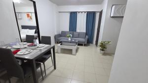 a small living room with a table and a couch at Plumera Mactan Condominium near Airport in Bankal