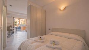 a bedroom with a bed with towels on it at Dimoras Central Studio 4 Guests Parking in Olbia