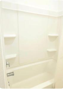 a white bathroom with a shower and a sink at Luxe Haven in Richmond