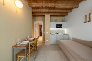 a living room with a table and a couch at Spaccavento Boutique Rooms in Chioggia