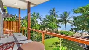a balcony with a view of the ocean at Sandveil Absolute Beachfront Access House in Trinity Beach +57 photos