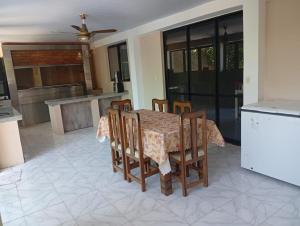 a dining room with a table and chairs in a kitchen at Roli in Clorinda