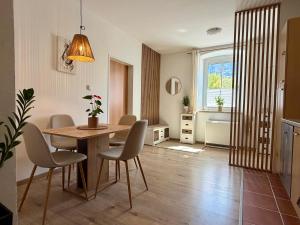 a living room with a dining room table and chairs at Traunzeit Apartment in Ebensee