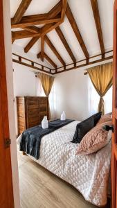 a bedroom with a large bed in a room at Boutique La Gloria in Villa de Leyva