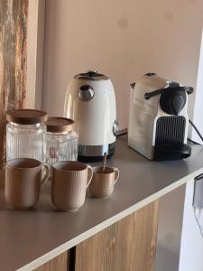 a counter with coffee cups and a toaster on it at Mirramor in Campo de Mirra