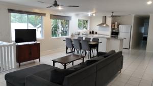a living room with a couch and a kitchen at Tully Motel in Tully