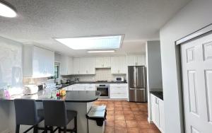 a kitchen with white cabinets and a black counter top at Joe West Vancouver Lodge in West Vancouver