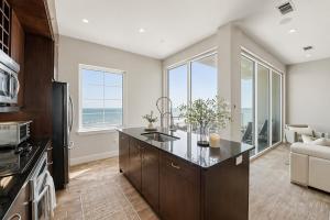 a kitchen with a kitchen island with a view of the ocean at Diamond Beach in Galveston