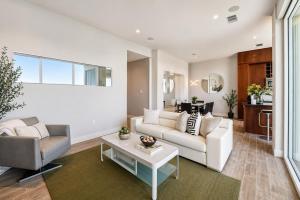 a living room with a white couch and a table at Diamond Beach in Galveston