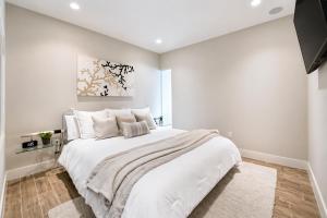 a white bedroom with a large white bed in it at Diamond Beach in Galveston +22 photos