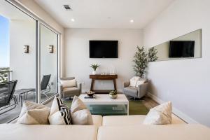 a living room with a white couch and chairs at Diamond Beach in Galveston