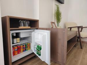 a refrigerator with its door open in a room at Apartmani PASHA in Nikšić
