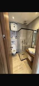 a bathroom with a shower and a toilet and a sink at Diyafa Invest in Oulad Akkou