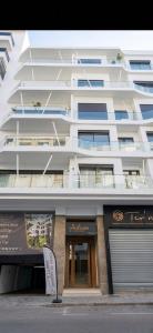 a large white building with a store in front of it at Diyafa Invest in Oulad Akkou