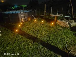 a garden with lights in the grass at night at Lacrima del Mare in Zalaegerszeg