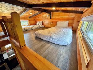 a bedroom in a log cabin with a bed at Tiny Home Topline in Carroll