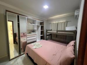 a small room with a bed and a mirror at Residencial Villa dos Corais - Staybeach in Porto Seguro +23 photos
