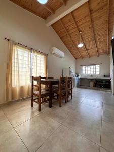 a kitchen and dining room with a table and chairs at Cabaña en cañuelas in Cañuelas