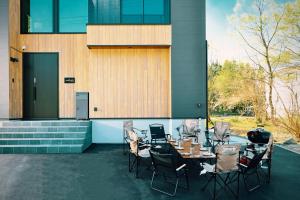 a group of tables and chairs in front of a building at Forest Resort Walnut in Hakuba