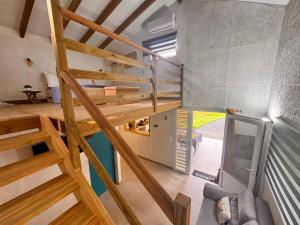 a loft conversion of a house with wooden stairs at Bungalow confortable et calme sud de la Martinique in Rivière-Salée +9 photos