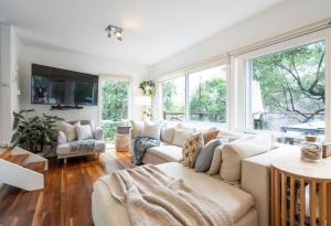 a living room with a couch and a large window at Surf Haven in Lorne