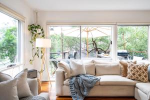 a living room with a couch and a window at Surf Haven in Lorne