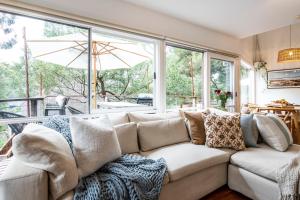 a living room with a couch and a large window at Surf Haven in Lorne +46 photos