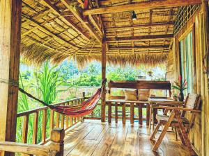 a hammock in a resort room with a hammock at Family Batcave Homestay in Battambang