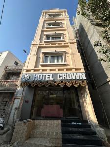 a hotel building with a hotel group sign on it at Hotel Crown in Dwarka