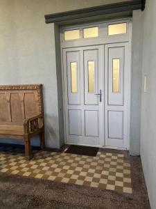 a white door with a bench next to it at Avram Iancu 365 in Floreşti