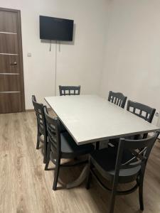 a white table and chairs in a room at Avram Iancu 365 in Floreşti