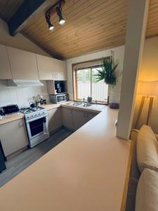 a kitchen with white appliances and a couch at Hannahs Haven in Traralgon
