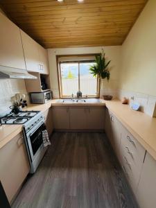 a small kitchen with a stove and a sink at Hannahs Haven in Traralgon +13 photos
