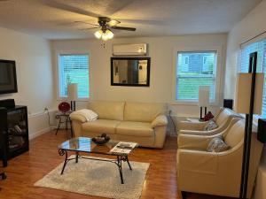 a living room with a couch and a table at Memory Lane Guest Suite in Sooke