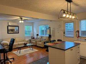a kitchen and living room with a table and chairs at Memory Lane Guest Suite in Sooke