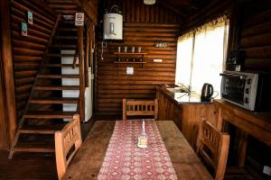 a dining room with a table in a cabin at Gasty Ranch in Mar del Plata