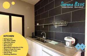a kitchen with a sink and a black tiled wall at Harmony Serene 3BR Nomad Sematan Beach Resort in Sematan +17 photos