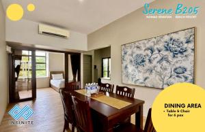 a dining room with a table and a painting on the wall at Harmony Serene 3BR Nomad Sematan Beach Resort in Sematan
