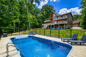 a swimming pool in front of a house at Ultimate LKA Retreat Boatdock Heated Pool Hottub in Mineral