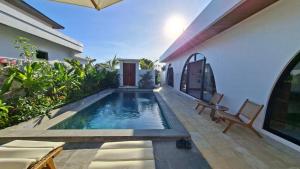 a swimming pool in the backyard of a house at Casa Anagata Pandawa in Ungasan