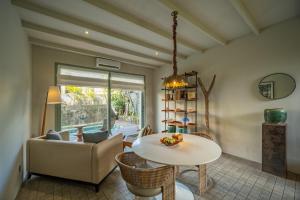 a living room with a table and a chair at Studio O - Two-Floor Studio, Walk to the Beach in Seminyak