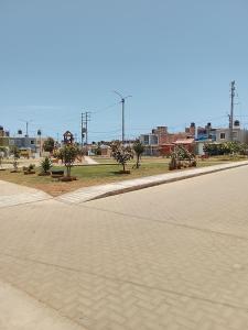 an empty street with trees on the side of the road at departamento familiar privado trujillo huanchaco in Huanchaco