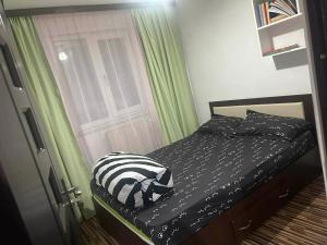 a bedroom with a bed with a zebra blanket and a door at Apartament Home M in Drobeta-Turnu Severin
