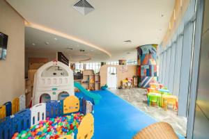a room with a play room with a toy house at Panorama Blue Beach Nha Trang in Nha Trang